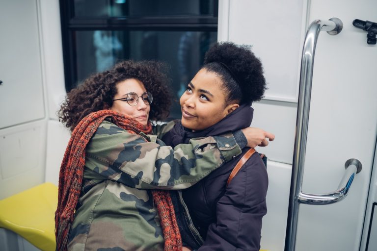 two young girls sitting in the metro